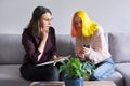 Woman psychologist working with teen girl. Visit and counseling of professional mental and social therapist Royalty Free Stock Photo