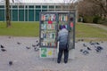 Woman at a public book shelve at the lakeside of Biel / Bienne, Switzerland