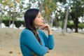 Woman in a public park with an attitude of preoccupation Royalty Free Stock Photo