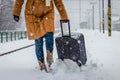 Woman pulling heavy luggage at a snow railroad station Royalty Free Stock Photo