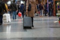 Woman pulling her trolley in a train station Royalty Free Stock Photo