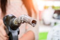 Woman pumping gasoline fuel in car at gas station. Royalty Free Stock Photo