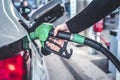 Woman pumping gasoline fuel in car at gas station. Royalty Free Stock Photo