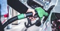 Woman pumping gasoline fuel in car at gas station. Royalty Free Stock Photo