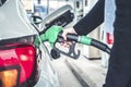 Woman pumping gasoline fuel in car at gas station. Royalty Free Stock Photo