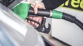 Woman pumping gasoline fuel in car at gas station. Royalty Free Stock Photo