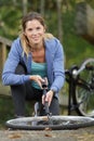 Woman pumping up bike tire using hand pump