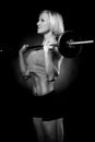 woman pumping up muscules with dumbbells Royalty Free Stock Photo