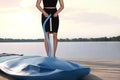 Woman pumping up SUP board on pier, closeup. Space for text Royalty Free Stock Photo
