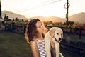 Woman with puppy dog at sunset