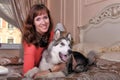 Woman with a puppy Malamute