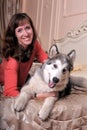 Woman with a puppy Malamute