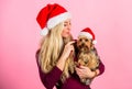 Woman with puppy wear santa hat. Celebrate christmas with pets. Ways to have merry christmas with pets. Reasons to love