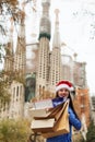 Woman with purchases against Sagrada familia