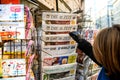 Woman purchases a Die Zeit german newspaper from a newsstand