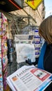 Woman purchases USA TODAY newspaper from a newsstand