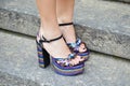 Woman with purple, blue and golden metallic high heel shoes before Frankie Morello fashion show,