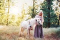 Woman in purple dress hugging white unicorn horse. Dreams come t Royalty Free Stock Photo