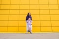 Woman in purple hoody have fun with cute girl 4-5 years old. Mommy and little daughter on yellow mall wall Royalty Free Stock Photo