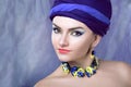 Woman in purple in jewelry of pansies Royalty Free Stock Photo