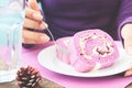 Woman in purple knit clothing eating blueberry roll cake, Purple