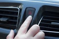 Women finger hitting car emergency red light button in car. Royalty Free Stock Photo