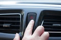 Women finger hitting car emergency red light button in car.