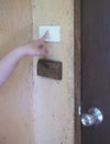 Woman pushing button door bell Royalty Free Stock Photo