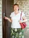 Woman pushing button of house intercom Royalty Free Stock Photo