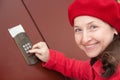 Woman pushing a door bell button Royalty Free Stock Photo