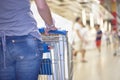 Woman pushing shopping cart in shopping mall Royalty Free Stock Photo