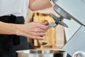 Woman put in hook nozzle in electric mixer