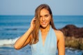 Woman put spf and sunscreen on face.Portrait of the beautiful girl close-up snow-white smile,blue eyes and perfectly