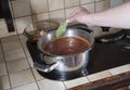 a woman puts a bay leaf in a saucepan,ingredients for cooking borsch soup