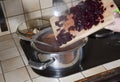 a woman puts a beetroot in a pot, ingredients cooking borsch soup