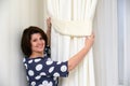 Woman puts clamps on curtains Royalty Free Stock Photo