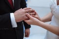 A woman puts a gold ring on the finger of a beloved man. Wedding day of loving people. French manicure at the bride. Royalty Free Stock Photo