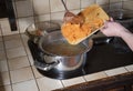 a woman puts grated carrots in a pan, ingredients for cooking borsch soup