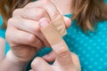 Woman puts a plaster on her injured finger Royalty Free Stock Photo