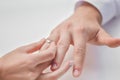 A woman puts a ring on her man& x27;s finger. Royalty Free Stock Photo