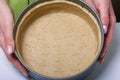 A woman puts the rolled dough into a baking dish. Close-up shot. Levington cake, stages of preparation Royalty Free Stock Photo