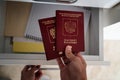 A woman puts Russian passports in a drawer, on a shelf. Travel forbidden