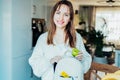 Woman putting apple and daily pills organizer into her bag. Taking daily medicine antioxidant diet vitamin supplements Royalty Free Stock Photo