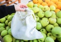 Woman is putting apples in reusable shopping bag. Zero waste. Ecologically and environmentally friendly packets. Canvas and linen Royalty Free Stock Photo