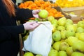 Woman is putting apples in reusable shopping bag. Zero waste. Ecologically and environmentally friendly packets. Canvas and linen Royalty Free Stock Photo