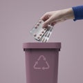 Woman putting expired drugs in the trash bin