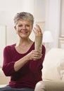 Woman Putting Brace on Hand Royalty Free Stock Photo