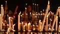 Woman putting candles in candlestick in church