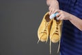 Woman putting capsule shoe freshener in footwear on color background Royalty Free Stock Photo