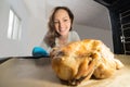 Woman Putting Chicken View From Inside The Oven Royalty Free Stock Photo
